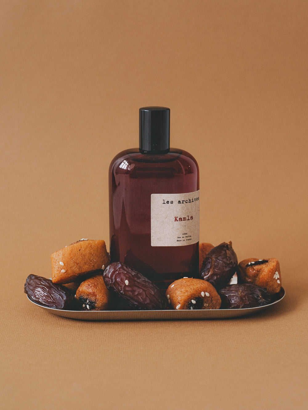 Les Archives Kamla 100ml– parfum en flacon, mise en scène avec dattes et Makrout photographie produit.